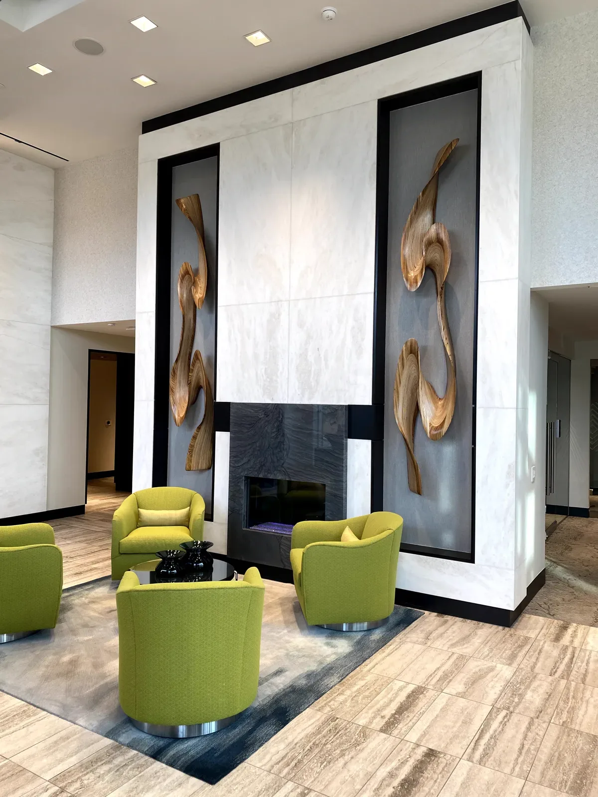 Illuminated dimensional stone fireplace wall at Telek Place