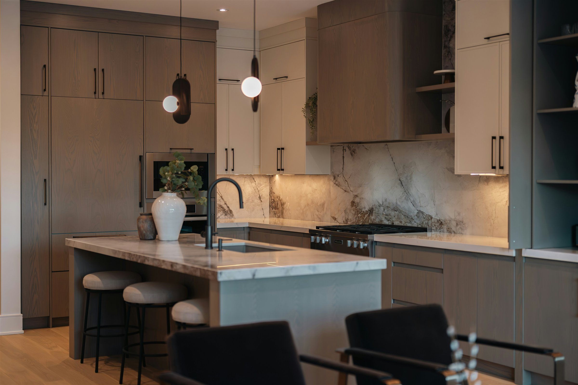 Full-height stone backsplash and countertop installation in a finished kitchen